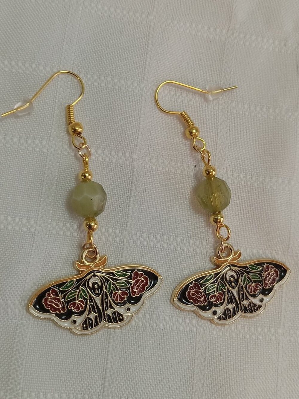 Handmade gold-colored earrings with multicolored enameled butterflies and beads